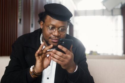 Santa hat Chinese youth on phone - 中国で毎年繰り返されるクリスマス論争、今年の奇妙な標的は「サンタ帽」？若者たちのネットミーム化する抵抗戦